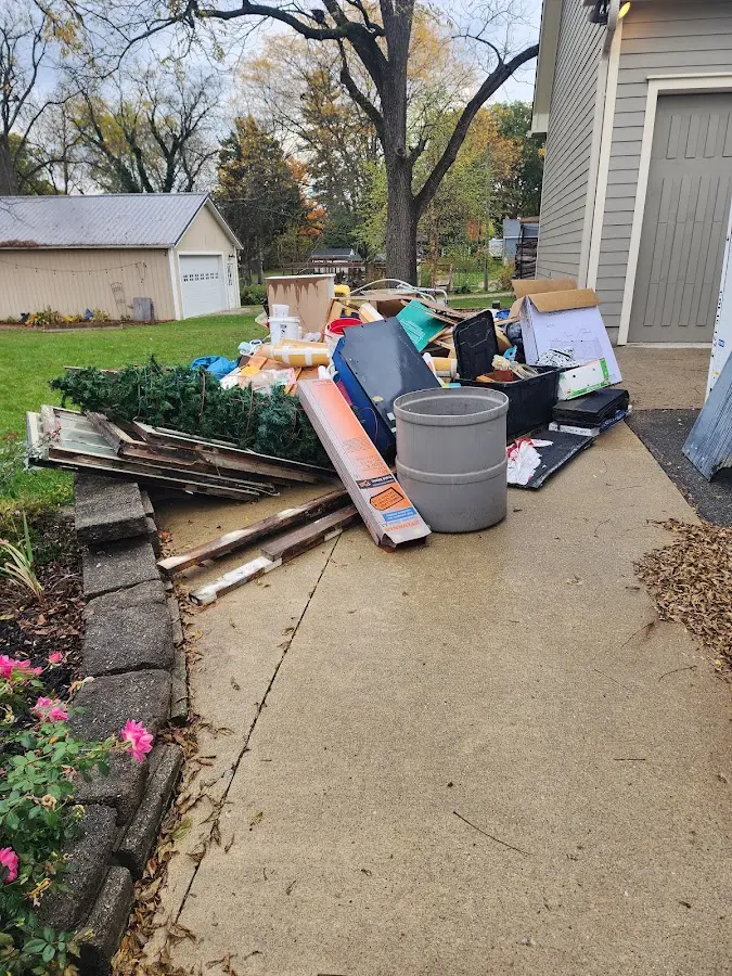 Dumpster being loaded with debris for Roofing Dumpster Rental in Severn